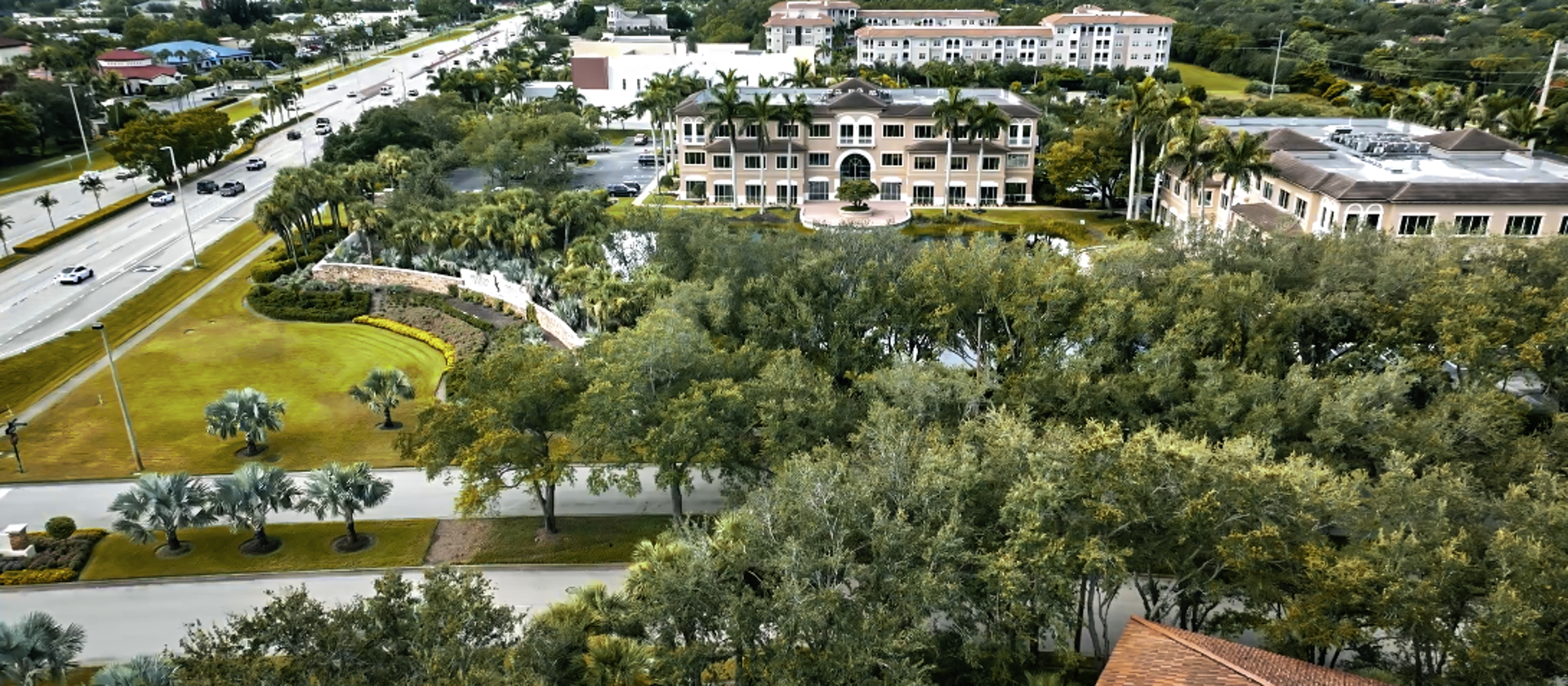 A scenic aerial view of a Florida coastline, with palm trees and luxury homes highlighting the wealth and lifestyle of the area.
