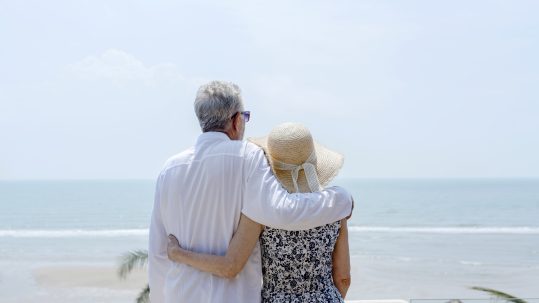 Couple in Naples, Florida meeting with financial advisor to review retirement tax benefits.