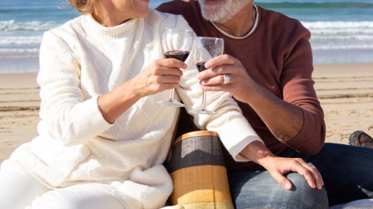 Retirees in Southwest Florida meeting with a financial advisor to review withdrawal and tax strategies.