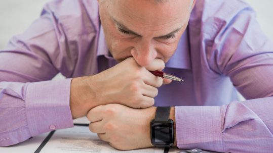 Financial advisor reviewing a comprehensive wealth management plan with clients in Southwest Florida.