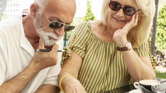Retirees reviewing a retirement income plan with a financial advisor in Southwest Florida during changing economic conditions.