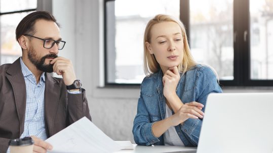 Clients discussing retirement tax planning questions with a financial advisor in Southwest Florida.