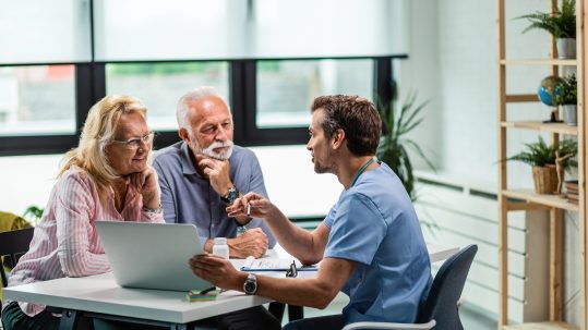 Financial advisor discussing advanced health care retirement planning strategies with clients in Southwest Florida.