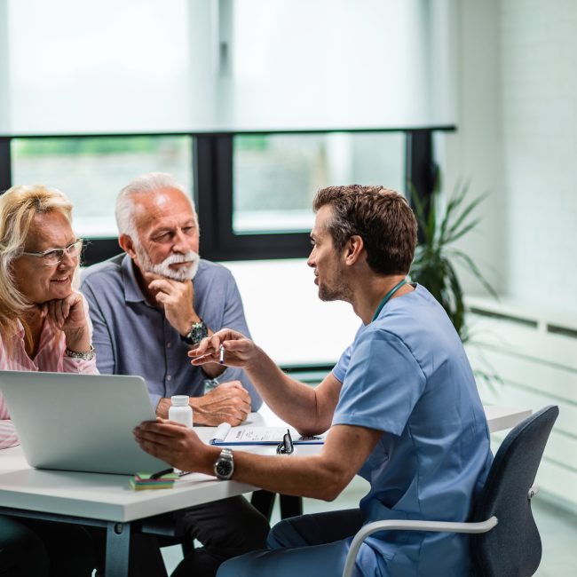 Financial advisor discussing advanced health care retirement planning strategies with clients in Southwest Florida.