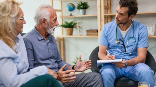 Financial advisor discussing healthcare retirement planning options with retirees in Southwest Florida.