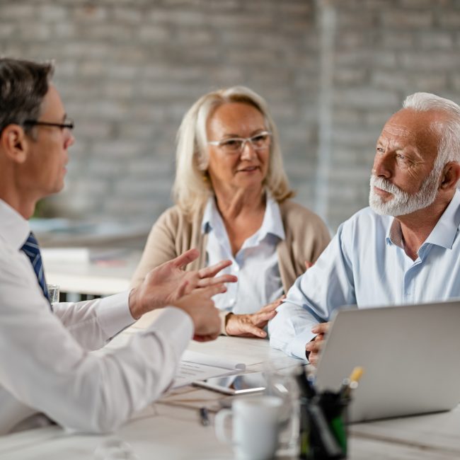 Financial advisor discussing retirement investment planning strategies with a family in Southwest Florida.