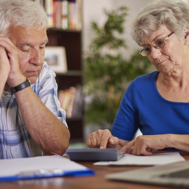Financial advisor explaining retirement tax planning mistakes to a client in Southwest Florida.