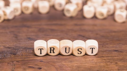 Family reviewing estate planning documents with financial advisor discussing irrevocable trust tax implications