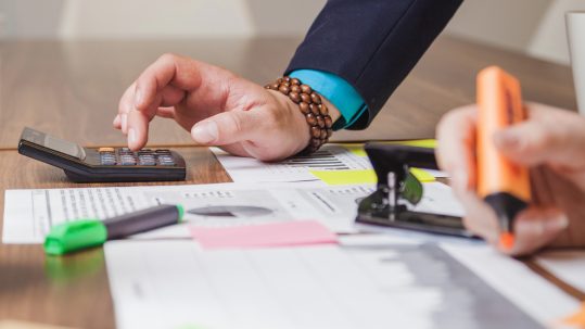 Financial advisor explaining retirement tax planning strategies to clients in Southwest Florida.