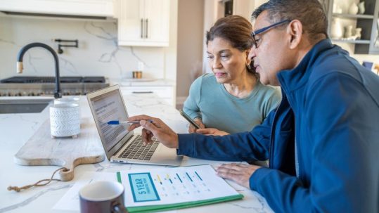 Retired couple meeting with financial advisor to discuss retirement income planning and investment withdrawal strategies