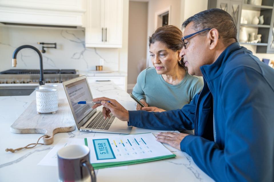 Retired couple meeting with financial advisor to discuss retirement income planning and investment withdrawal strategies