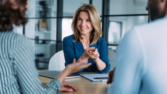 Couple meeting with financial advisor to discuss estate and retirement planning when one spouse is not a U.S. citizen