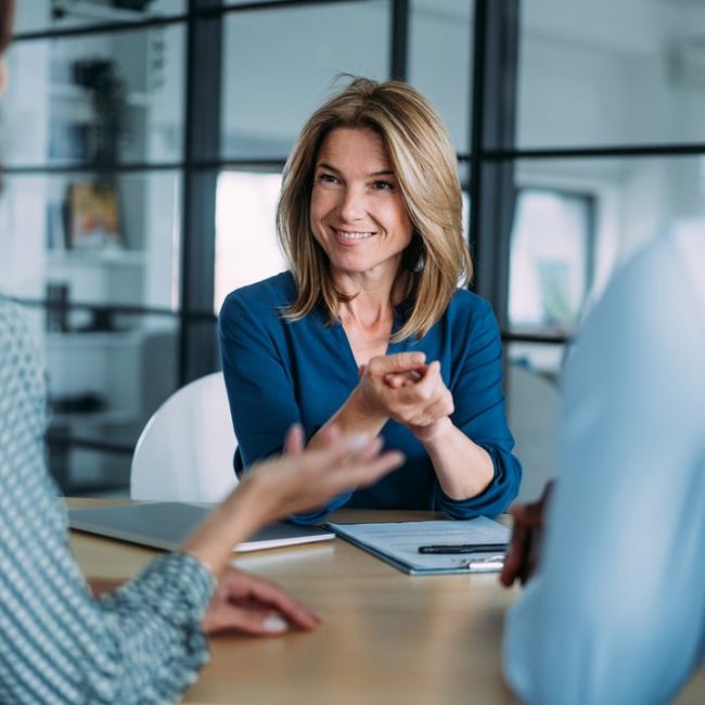 Couple meeting with financial advisor to discuss estate and retirement planning when one spouse is not a U.S. citizen