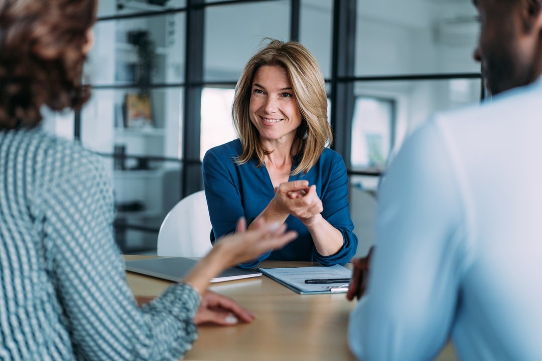 Couple meeting with financial advisor to discuss estate and retirement planning when one spouse is not a U.S. citizen
