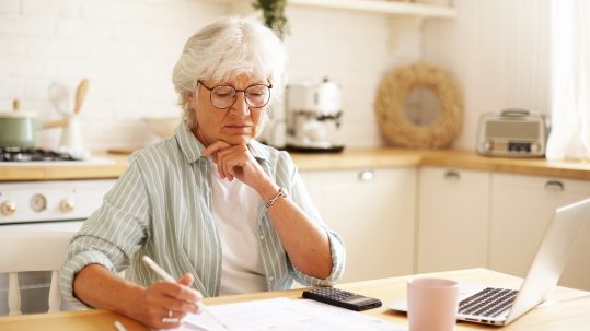 Financial advisor discussing retirement tax planning with a retired couple in Southwest Florida