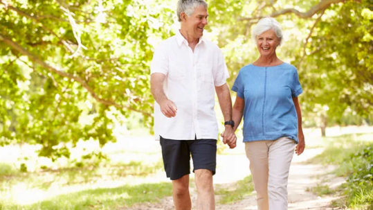 Retired couple planning for a long retirement with a financial advisor reviewing income and investment strategies