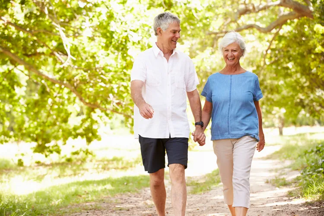 Retired couple planning for a long retirement with a financial advisor reviewing income and investment strategies