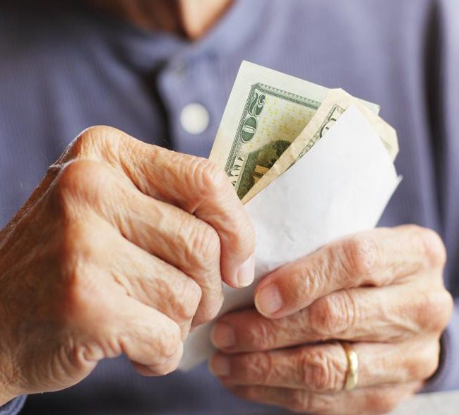 Retired couple reviewing cash reserves and retirement income strategy with financial advisor