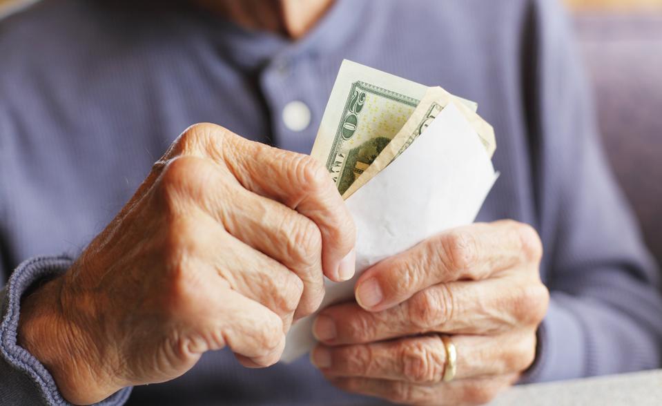 Retired couple reviewing cash reserves and retirement income strategy with financial advisor