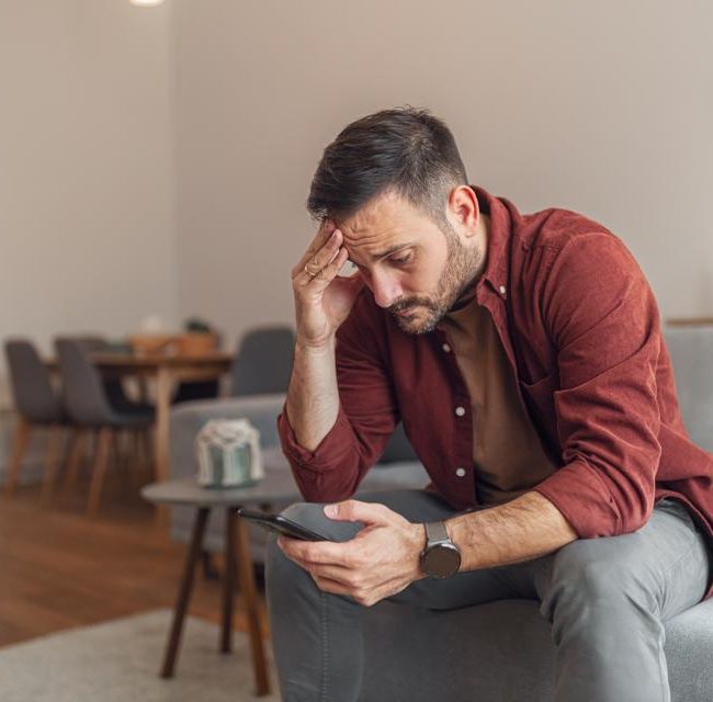 Person reviewing suspicious text message while learning how to avoid text scams and identity theft