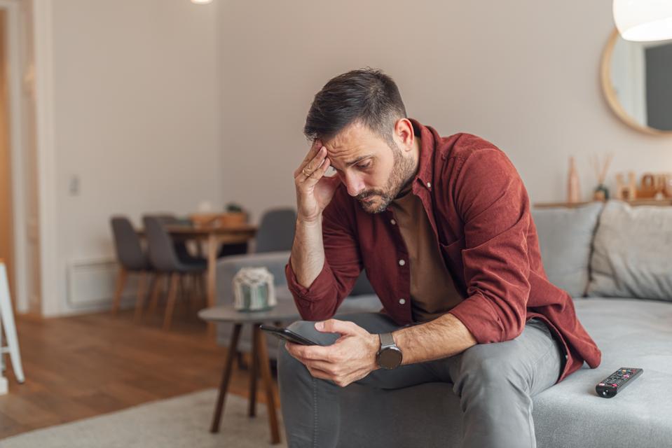 Person reviewing suspicious text message while learning how to avoid text scams and identity theft