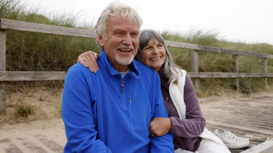 Retired couple reviewing longer life expectancy and retirement income planning with a financial advisor