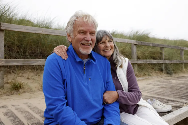 Retired couple reviewing longer life expectancy and retirement income planning with a financial advisor