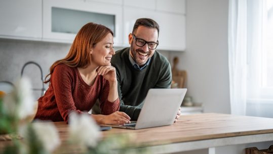 Married couple reviewing retirement accounts and 401(k) contribution strategies with a financial advisor
