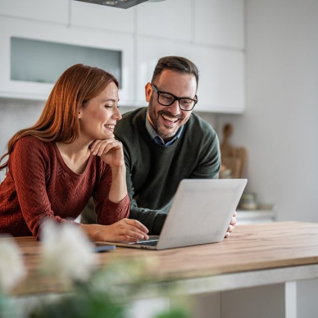 Married couple reviewing retirement accounts and 401(k) contribution strategies with a financial advisor