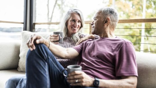 Retired couple discussing the emotional side of retirement planning with a financial advisor