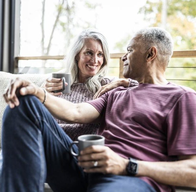 Retired couple discussing the emotional side of retirement planning with a financial advisor
