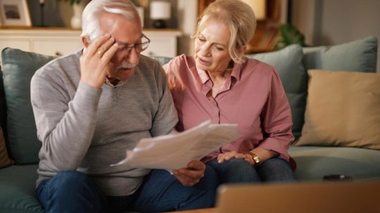 Retired couple discussing annuity and retirement income planning options with financial advisor