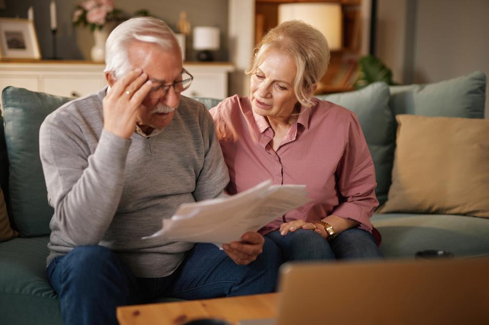 Retired couple discussing annuity and retirement income planning options with financial advisor