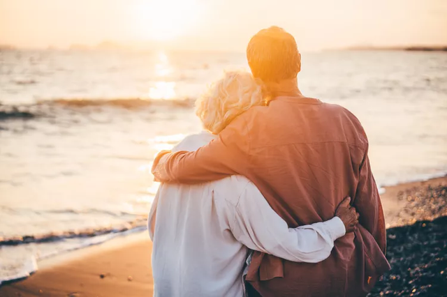 Retired couple reviewing IRA distribution and RMD planning with a financial advisor