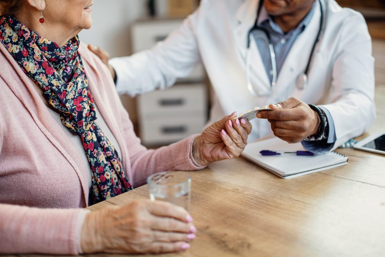 Retired couple reviewing Medicare options and healthcare costs with a financial advisor.